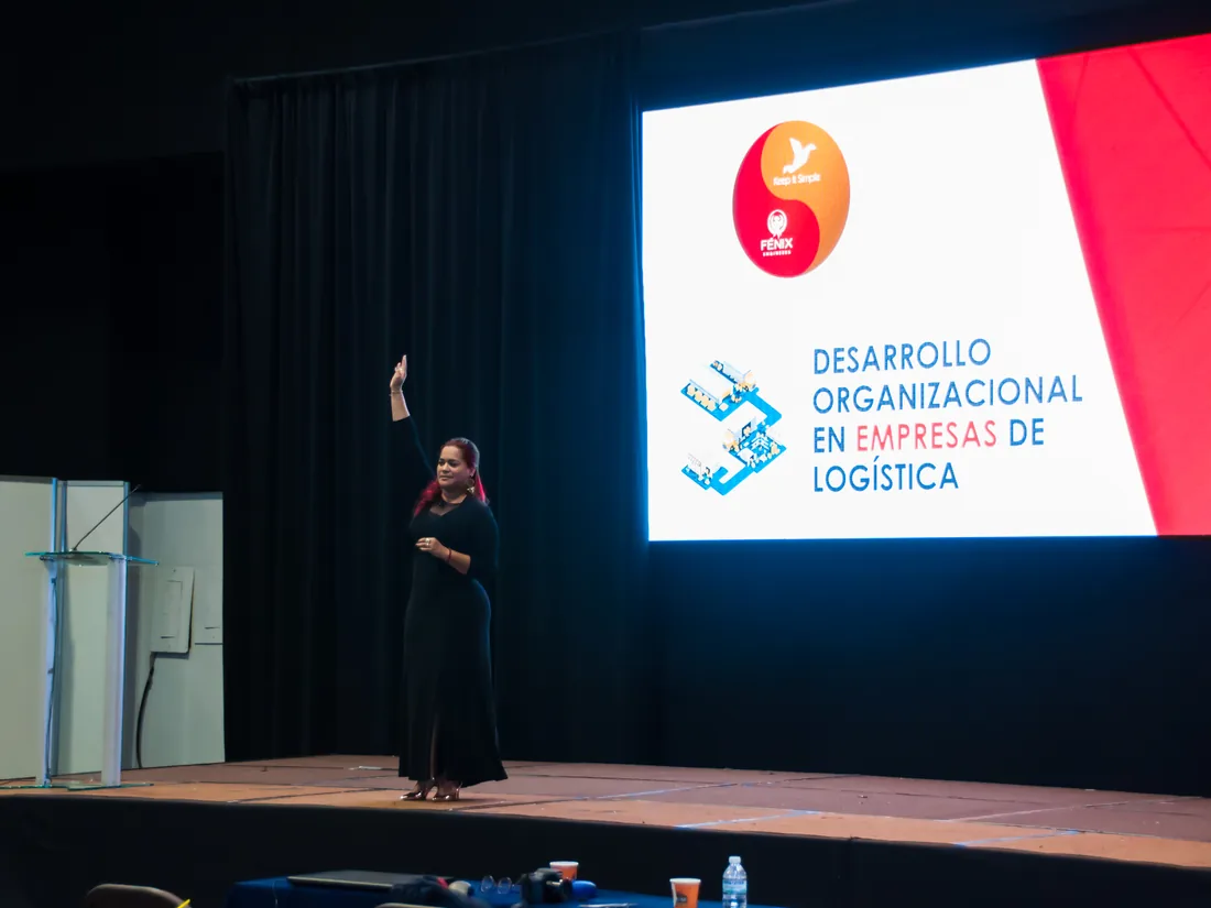 Kenelva Castrillón on stage at a conference