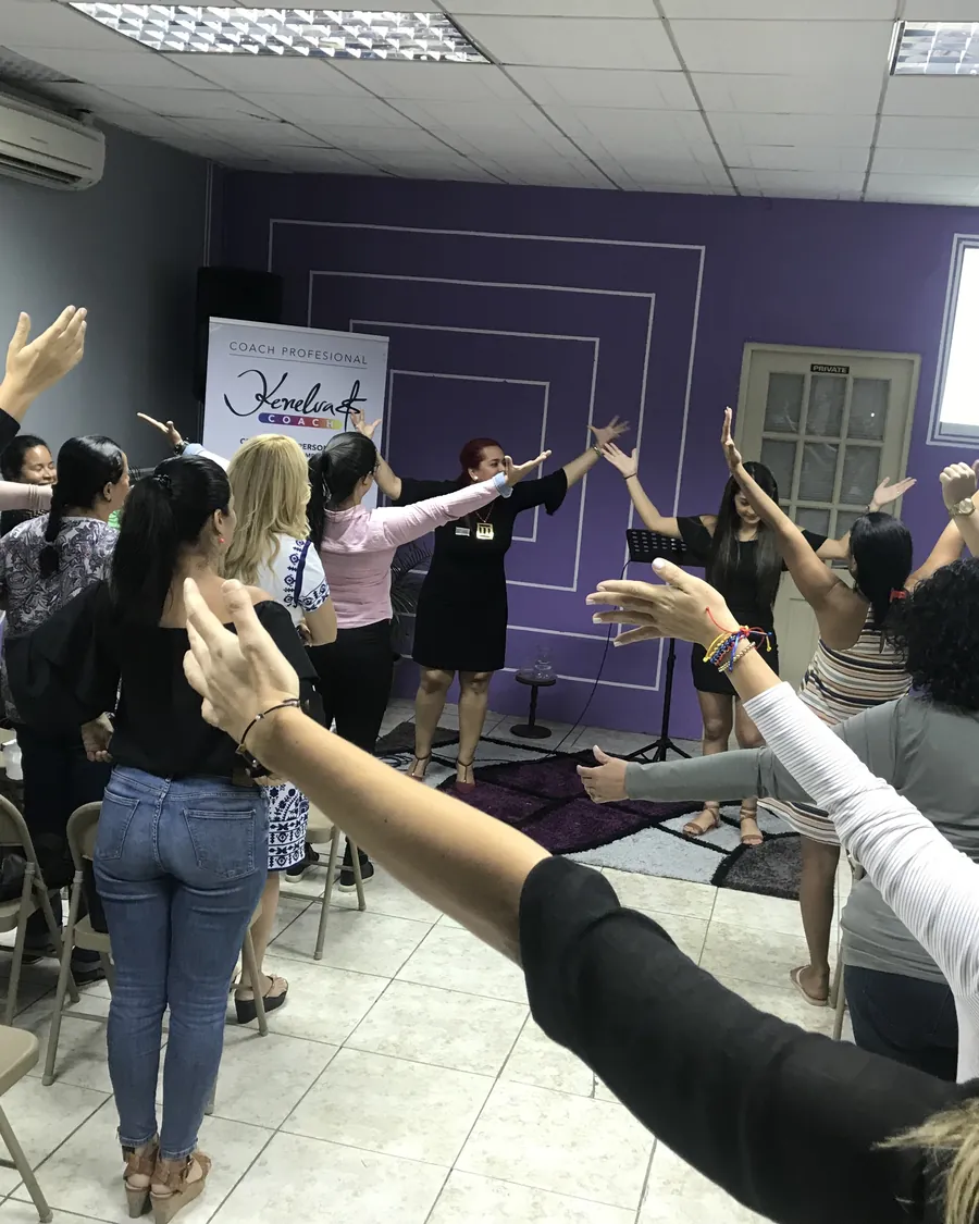 Participants with raised hands during a workshop